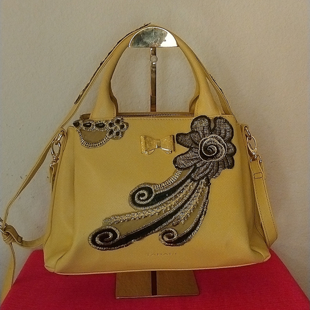 Tahari satchel embellished with shoulder strap.
